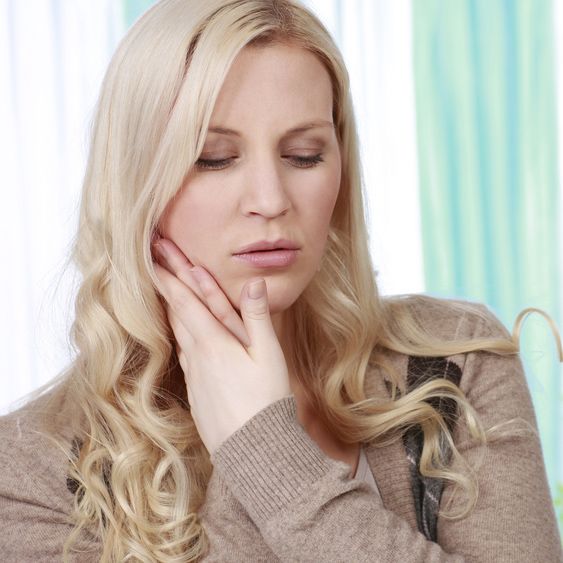 Blonde woman feeling tooth pain