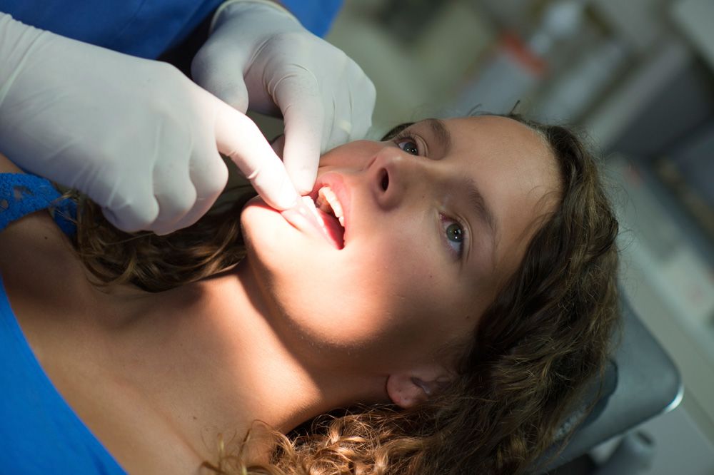 woman having her teeth inspected